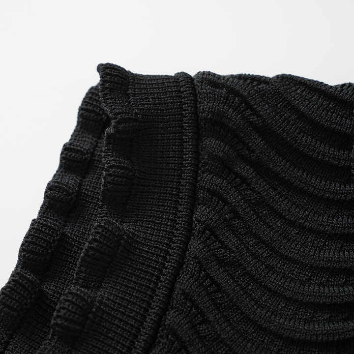 Black bodycon dress with textured wave pattern and ruffled collar and sleeves