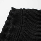 Black bodycon dress with textured wave pattern and ruffled collar and sleeves
