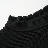 Black bodycon dress with textured wave pattern and ruffled collar and sleeves