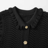 Black bodycon dress with textured wave pattern and ruffled collar and sleeves
