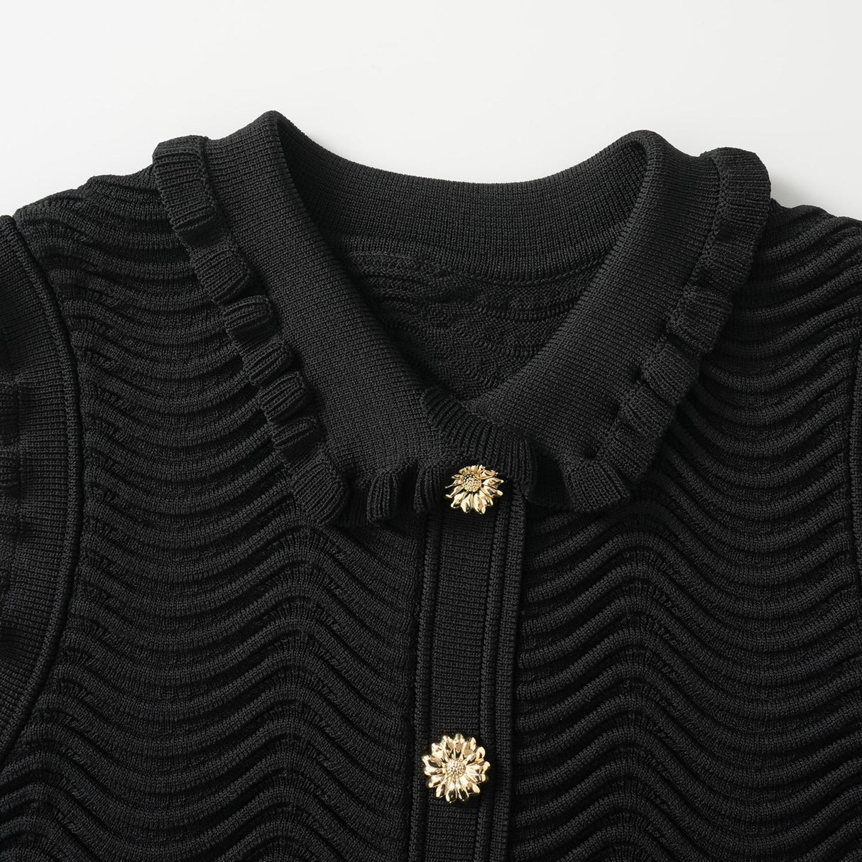 Black bodycon dress with textured wave pattern and ruffled collar and sleeves