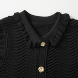 Black bodycon dress with textured wave pattern and ruffled collar and sleeves