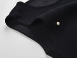Black fitted bodice dress with pearl embellishments and ruffle hem