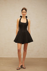 Black halterneck mini dress with bow detail named Quirine