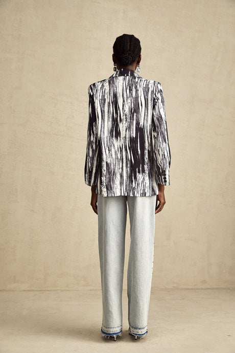 Black jacket with graffiti print design and textured fabric named Elise