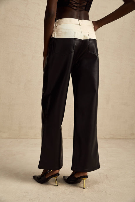 Black leather trousers with contrasting white side panels and waistband