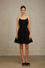 Black mini dress with faux pearl embellishments called Danae