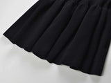 Black off-shoulder bodycon dress with bow detail and flared bottom