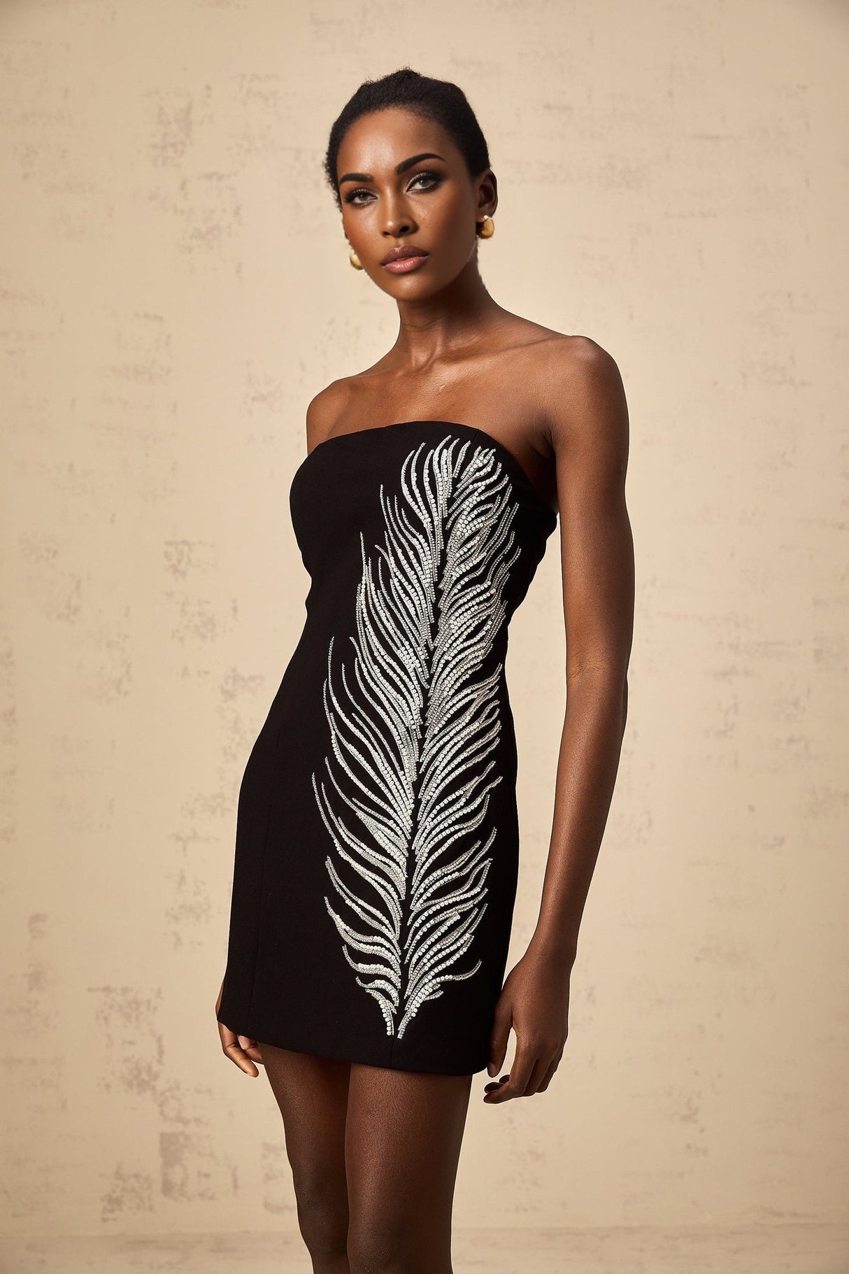 Black off shoulder mini dress with feather embellishments