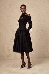 Black pleated midi skirt with flared silhouette named Pauline