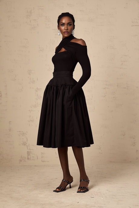 Black pleated midi skirt with flared silhouette named Pauline