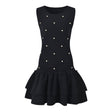 Black sleeveless dress with pearl embellishments and ruffle hem