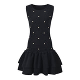 Black sleeveless dress with pearl embellishments and ruffle hem