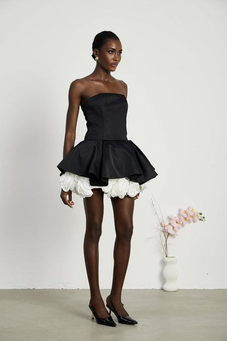 Black strapless mini dress with corset design and petal details called Lucie