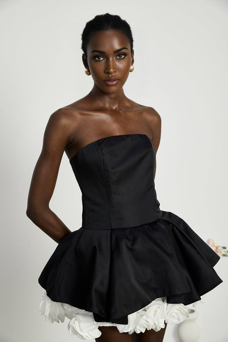 Black strapless mini dress with corset detail and floral petal accents named Lucie