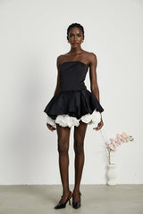 Black strapless mini dress with corset style and floral petal details named Lucie