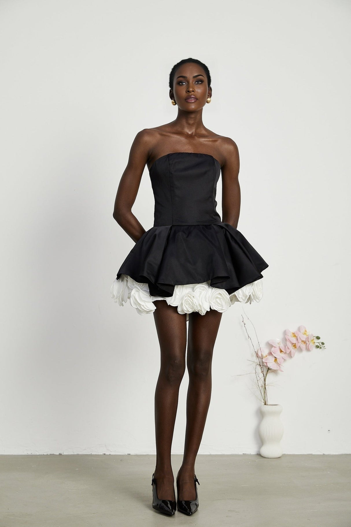 Black strapless mini dress with floral petal design and corset style bodice called Lucie