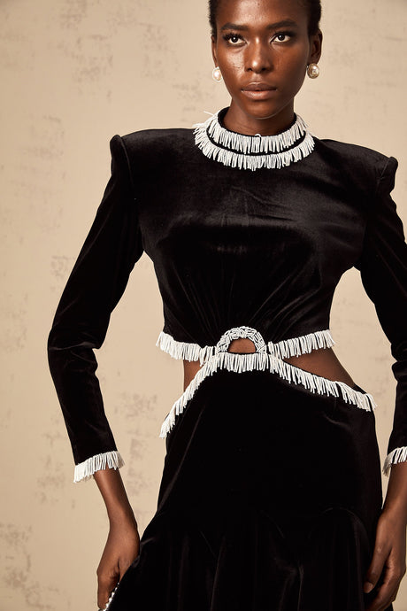Black velvet mini dress with cut out details and fringe trim named Daniela