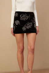 Black velvet mini skirt with sequin embellishments