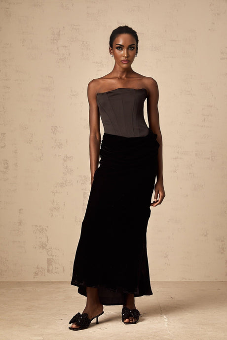 Black velvet off shoulder floor length dress with fitted bodice and flowing skirt