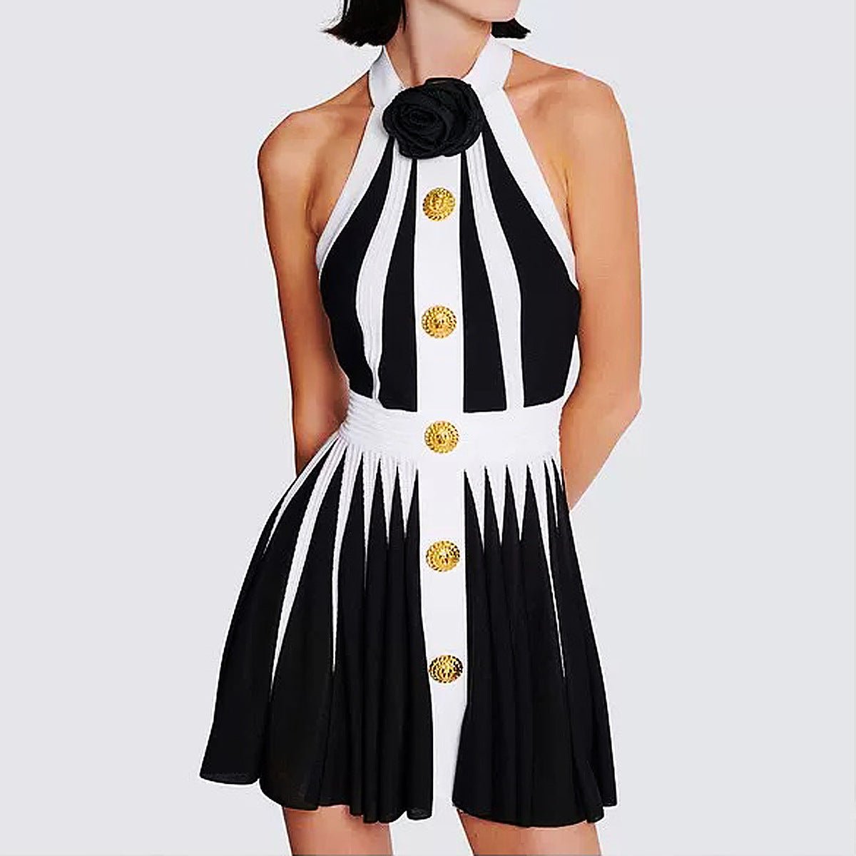 Black and white halter neck dress with gold accents and rose embellishment