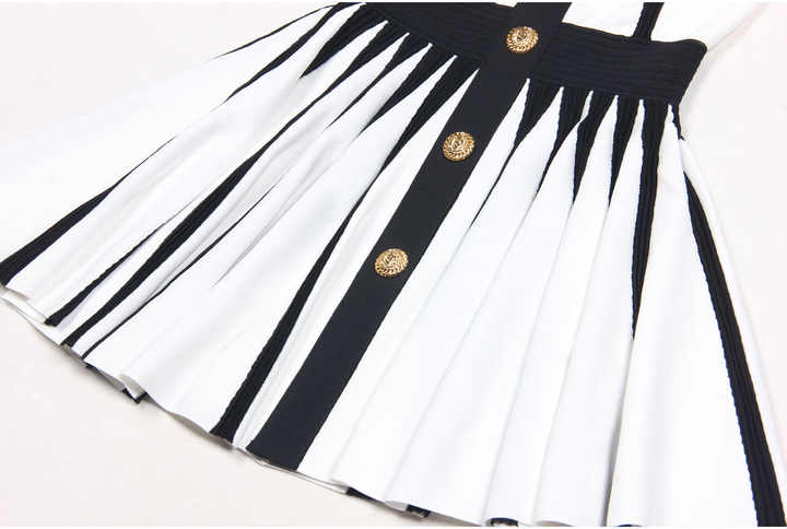 Black and white halter neck A-line dress with gold accents and rose embellishment