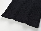 Sophia black ribbed knitted jacket with white accents and gold buttons paired with a matching bodycon skirt