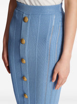 Blue high-waisted midi skirt with vertical ribbed texture and gold buttons