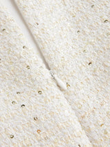 This elegant white dress features a textured fabric adorned with shimmering sequins that catch the light beautifully. Its.