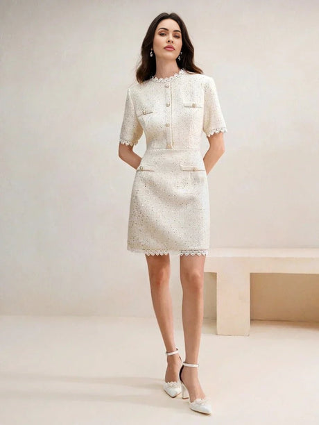 This chic ivory dress features a fitted silhouette with short sleeves and delicate lace trim, exuding elegance and.