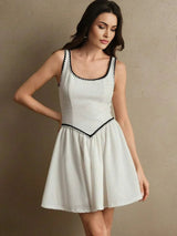This charming white dress features a flattering fit-and-flare silhouette, accentuated by delicate black trim along the.