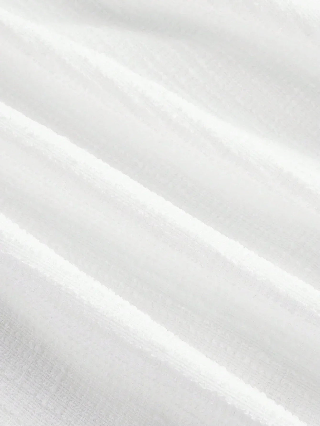 This elegant white dress features a flowing, lightweight fabric that drapes beautifully, enhancing its graceful silhouette..