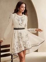 This elegant white dress features intricate floral embroidery and a flattering fit-and-flare silhouette, making it perfect.