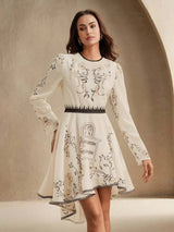 This elegant ivory dress features intricate floral embroidery in earthy tones, creating a charming contrast against the soft.