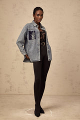 Closeup of light blue denim shirt with small rhinestone embellishments scattered across the fabric Ségolène brand visible on collar