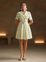 This charming light yellow dress features a fitted bodice with a stylish collar and flared skirt, accentuated by delicate.