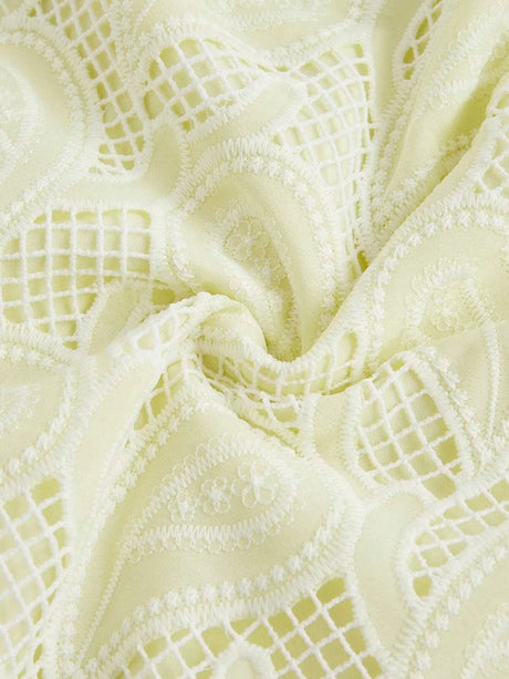 Delicate and airy, this light yellow dress features intricate lace detailing and a soft texture that drapes elegantly. The.