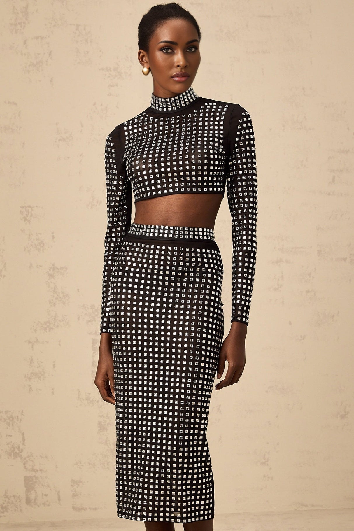 Elegant black matching set featuring a mesh top and skirt adorned with sparkling rhinestones Vera brand womens formal wear