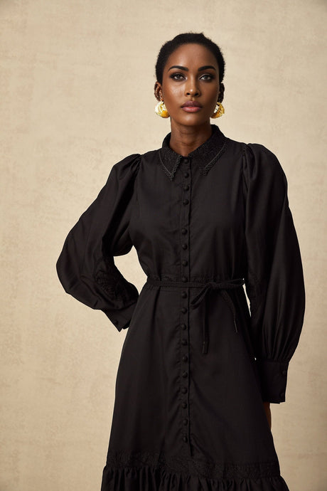 Elegant black midi dress with delicate lace embroidery details and a fitted silhouette