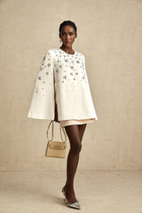 Elegant white jacket with cape design and embellished details featuring delicate beadwork and embroidery