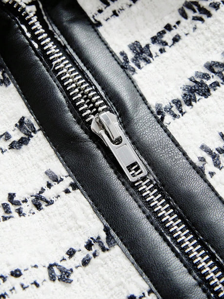 This stylish dress features a chic black and white design with intricate patterns, accentuated by a glossy black zipper that.
