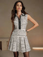 This chic dress features a striking black and white striped pattern, combining a tailored sleeveless design with a stylish.