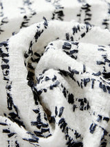 The dress features a chic black and white pattern with a textured fabric that offers a soft, cozy feel. Its relaxed fit.
