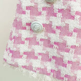 Pink houndstooth double-breasted blazer with silver buttons paired with matching high-waisted shorts