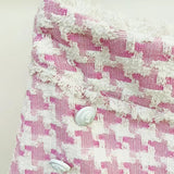 Pink houndstooth double-breasted blazer with silver buttons paired with matching high-waisted shorts