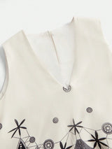 This elegant cream dress features a sophisticated V-neckline and delicate black embroidery, showcasing an intricate design.