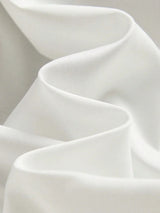 Experience the elegance of this flowing white dress, crafted from lightweight, breathable fabric that gently drapes for a.