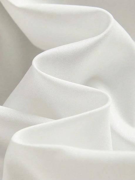 Experience the elegance of this flowing white dress, crafted from lightweight, breathable fabric that gently drapes for a.