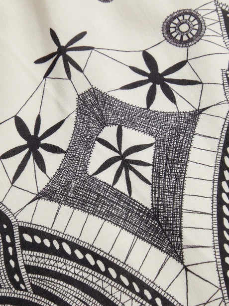This stylish dress features a stunning black and white geometric pattern, crafted from a lightweight, breathable fabric that.