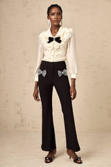 Flared trousers with a decorative bow embellishment named Gelsomina